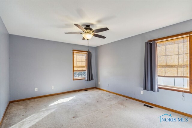 unfurnished room featuring ceiling fan and light colored carpet