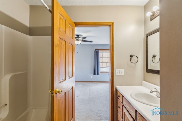 bathroom featuring vanity, ceiling fan, and bathtub / shower combination