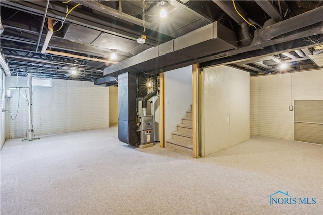 basement featuring carpet flooring and heating unit