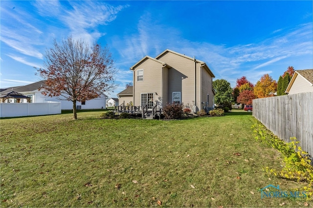 back of property featuring a lawn