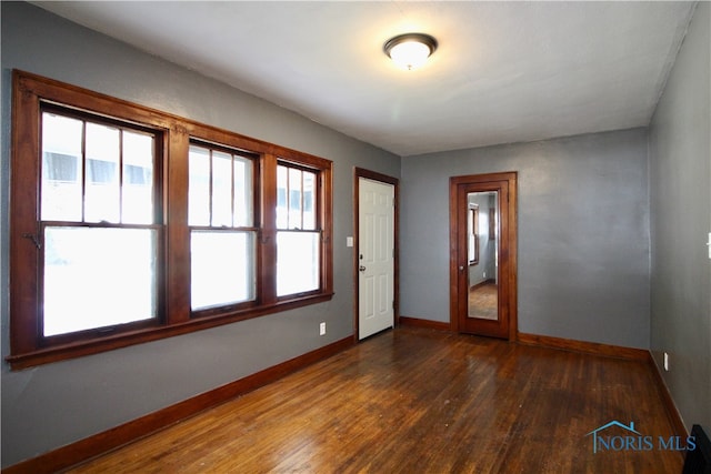 spare room with dark hardwood / wood-style flooring