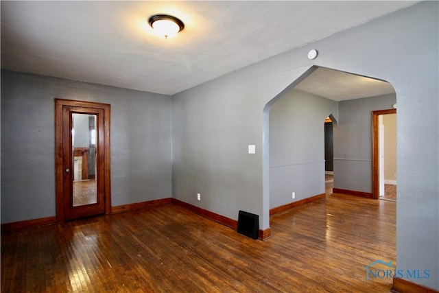 empty room with dark hardwood / wood-style floors