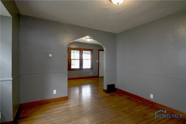 spare room featuring wood-type flooring