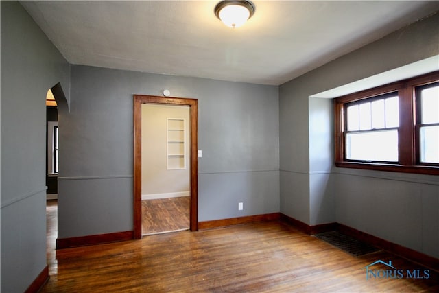 spare room featuring wood-type flooring