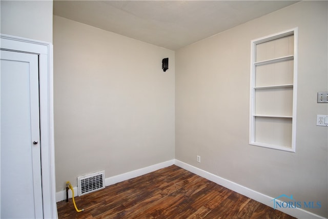 spare room featuring dark hardwood / wood-style floors