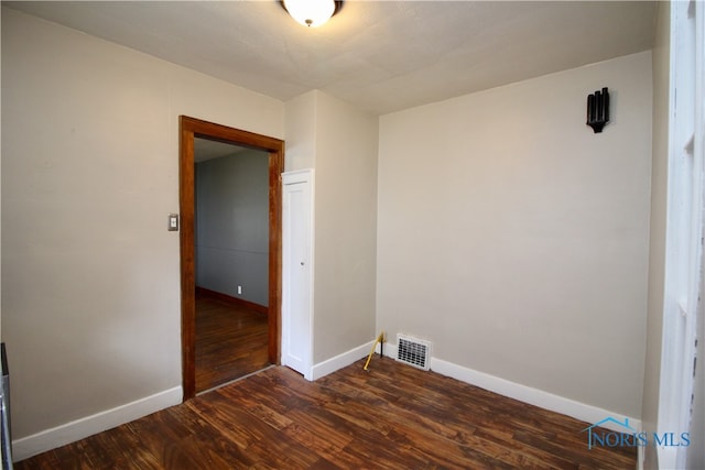 empty room featuring dark hardwood / wood-style floors