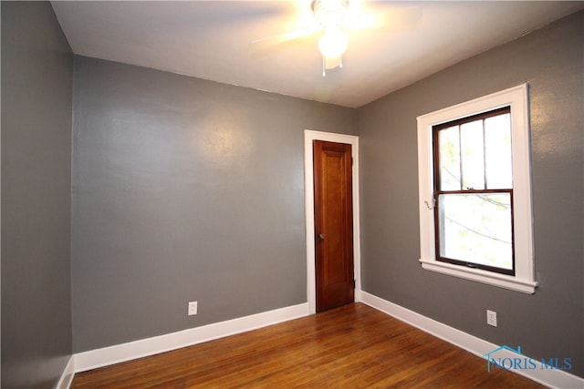 spare room featuring ceiling fan and dark hardwood / wood-style flooring