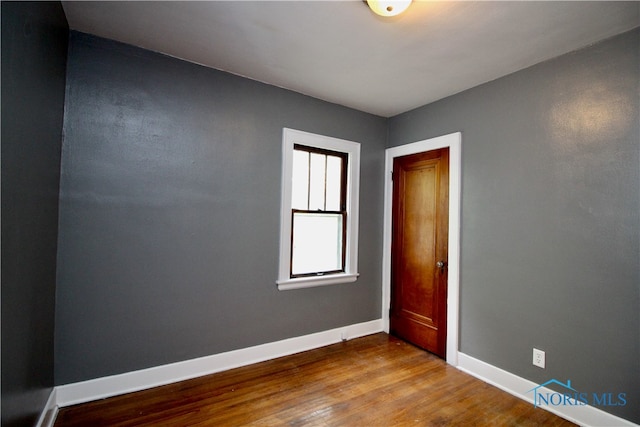 unfurnished room featuring hardwood / wood-style floors