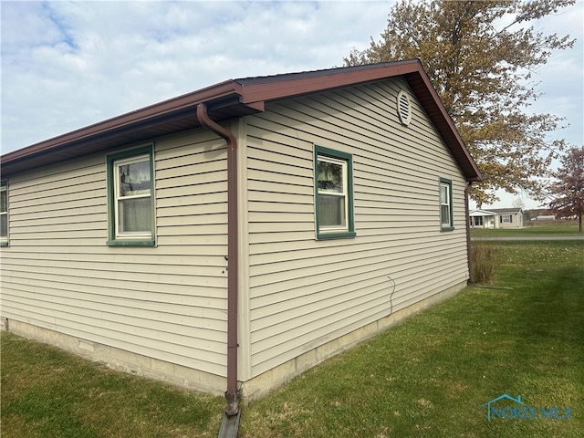 view of side of property with a lawn