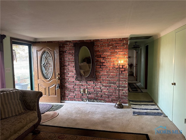 interior space featuring brick wall and carpet