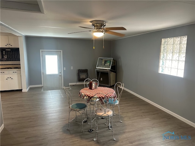 dining room with dark hardwood / wood-style floors and ceiling fan