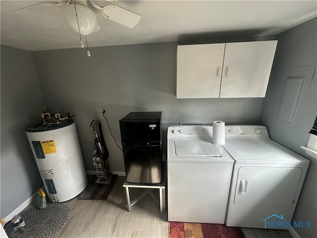 laundry room featuring cabinets, ceiling fan, washer and dryer, water heater, and light hardwood / wood-style floors