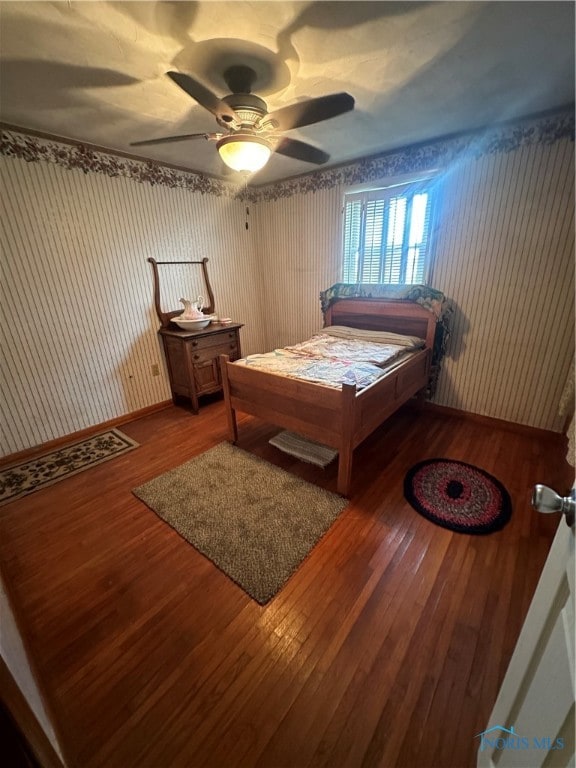 bedroom with ceiling fan and hardwood / wood-style floors