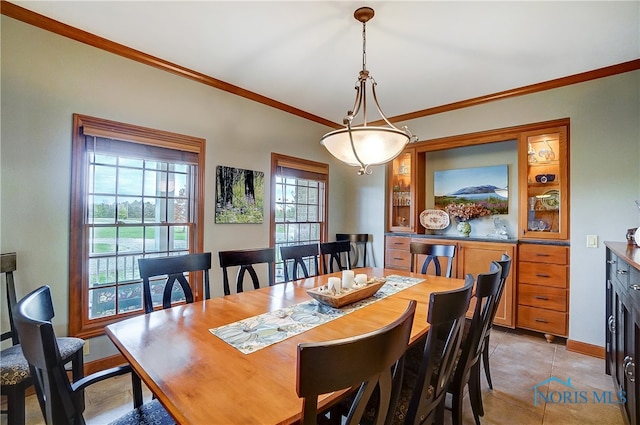 dining area featuring crown molding and light tile patterned flooring