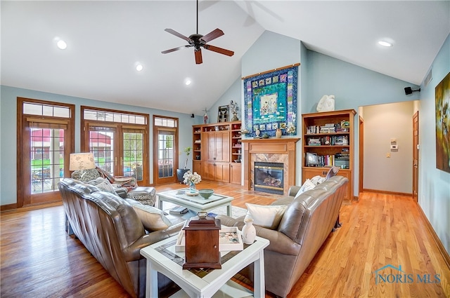 living room with french doors, light wood-type flooring, high vaulted ceiling, and ceiling fan