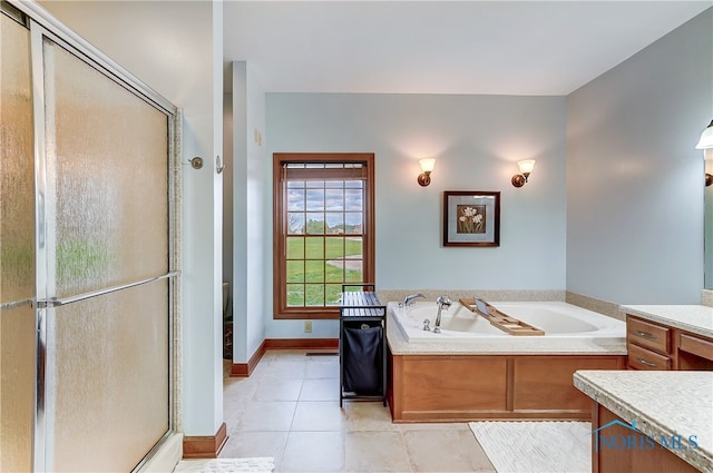 bathroom with shower with separate bathtub, vanity, and tile patterned floors