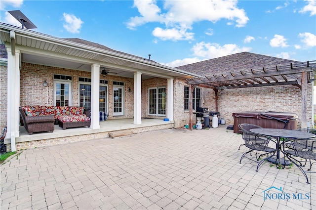 view of patio with a pergola, a hot tub, ceiling fan, and grilling area