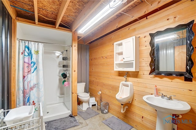 bathroom featuring curtained shower, wood walls, and toilet