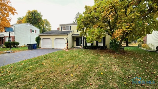 2263 Country Squire Ln, Toledo, OH 43615 - view of front facade featuring a garage, asphalt driveway, and a front yard