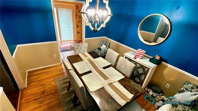 dining room featuring hardwood / wood-style floors and a notable chandelier