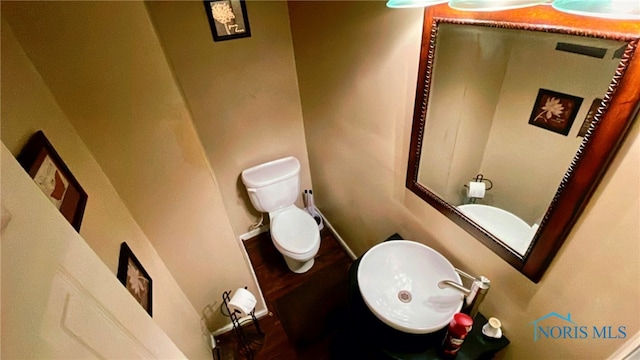 bathroom with sink, wood-type flooring, and toilet