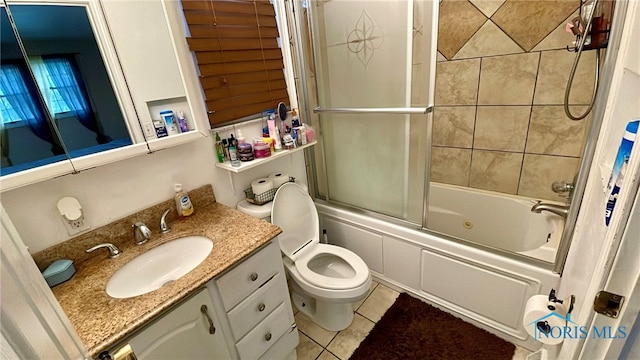 2263 Country Squire Ln, Toledo, OH 43615 - bathroom featuring tile patterned floors, vanity, bath / shower combo with glass door, and toilet