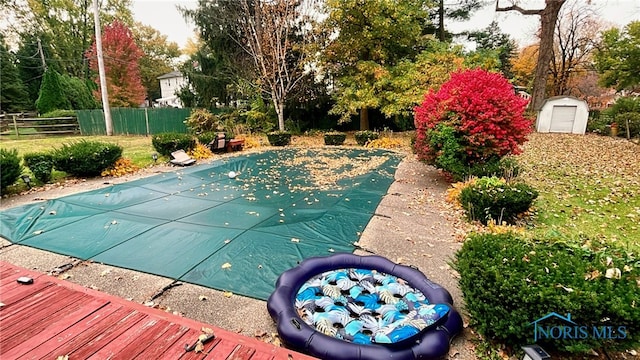 view of swimming pool featuring a shed