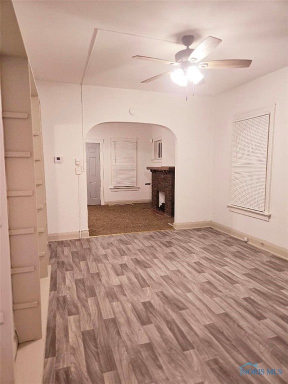 empty room with ceiling fan and wood-type flooring