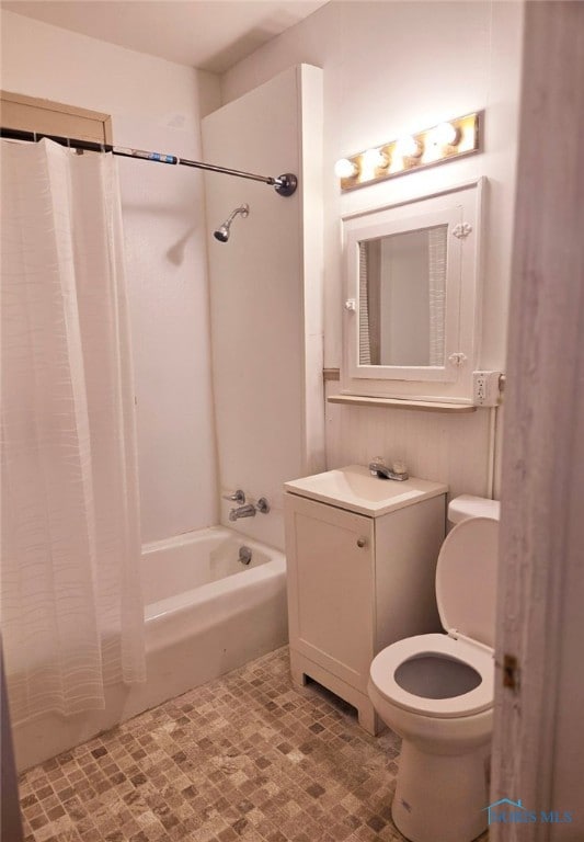 full bathroom with toilet, shower / tub combo, and vanity