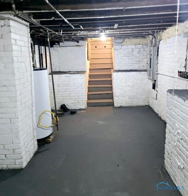 basement with electric panel and water heater