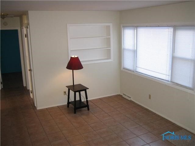 unfurnished room featuring tile patterned floors