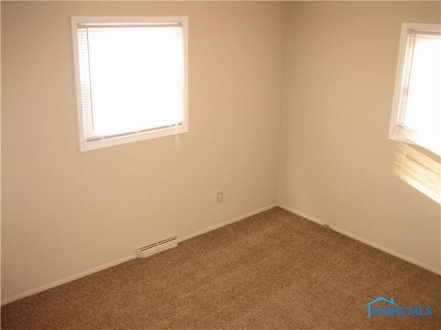 carpeted spare room featuring a healthy amount of sunlight