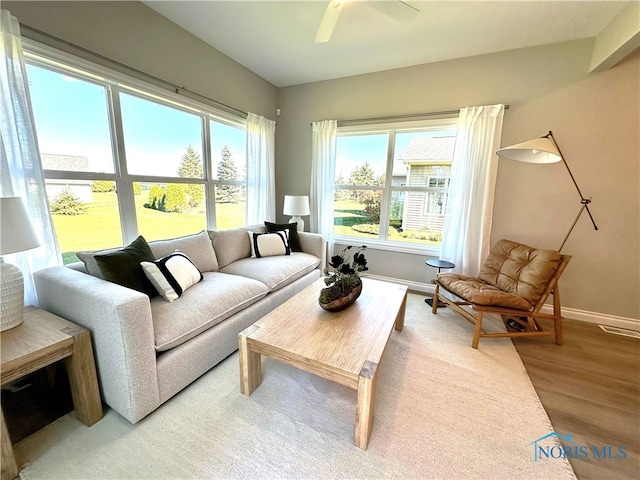 living room with ceiling fan, hardwood / wood-style flooring, and plenty of natural light