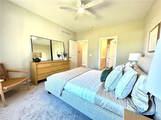 carpeted bedroom with ceiling fan and ensuite bath