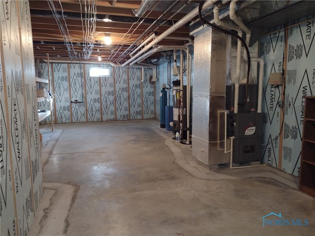 basement featuring water heater and heating unit