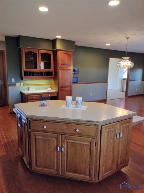 kitchen featuring a kitchen island, hanging light fixtures, and dark hardwood / wood-style floors