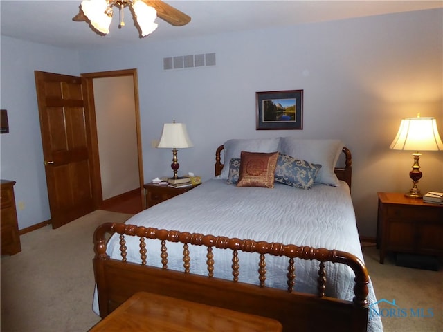 bedroom featuring light carpet and ceiling fan