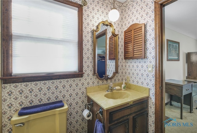 bathroom featuring vanity and toilet