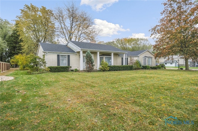 single story home featuring a front lawn