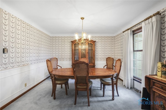 dining area with a chandelier and carpet floors