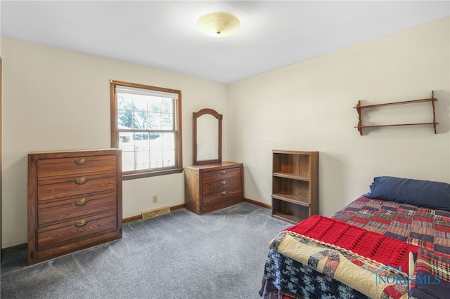 bedroom with dark colored carpet