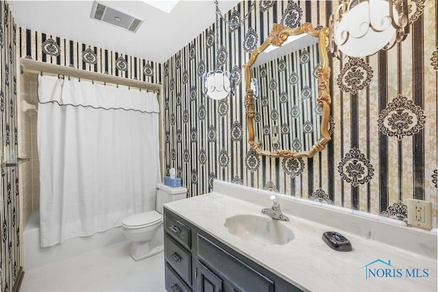 bathroom featuring toilet, curtained shower, and vanity