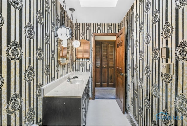 bathroom featuring vanity and a skylight