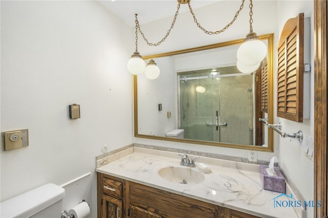 bathroom featuring vanity, toilet, and walk in shower