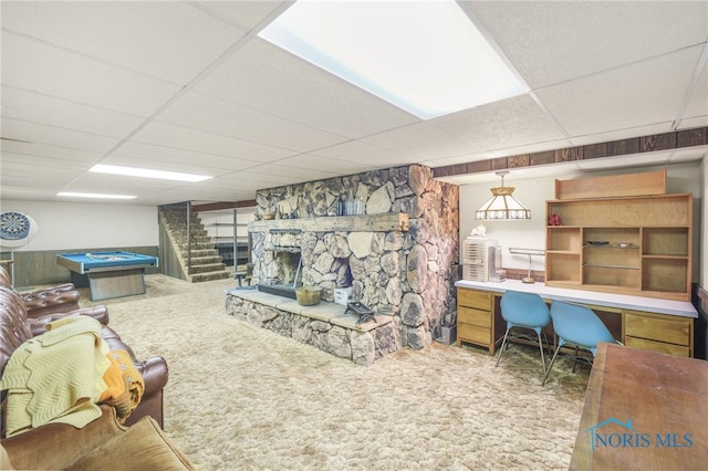 carpeted living room featuring a paneled ceiling, pool table, and a fireplace