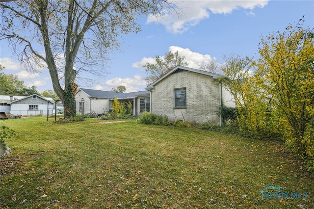 rear view of property with a yard