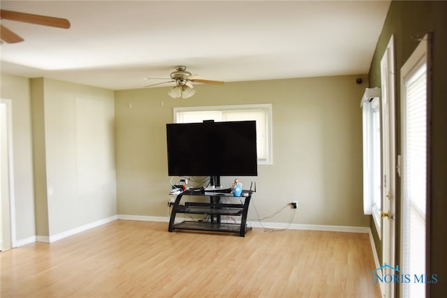 living room featuring ceiling fan and light hardwood / wood-style floors