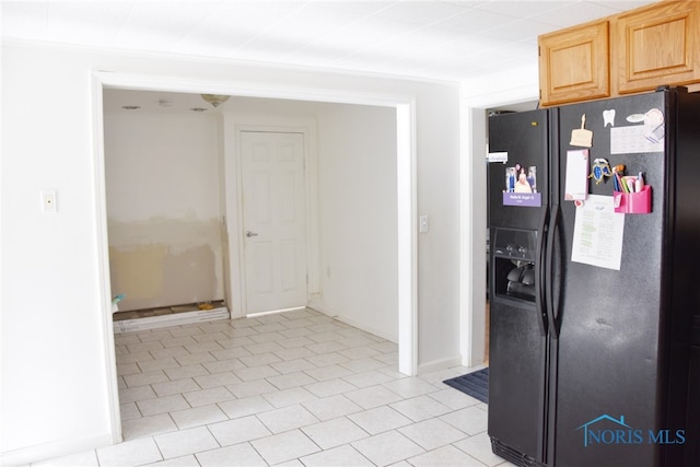 kitchen with light brown cabinetry, black fridge with ice dispenser, and light tile patterned flooring