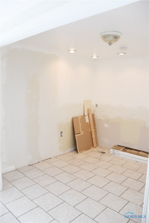 empty room featuring ornamental molding