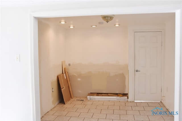 interior space with tile patterned floors and crown molding